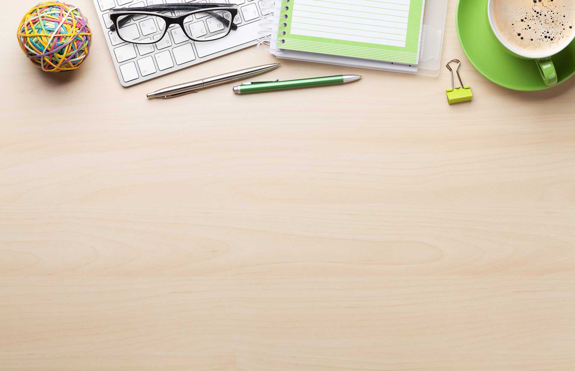 Photo of desk with notepad, pen and coffee